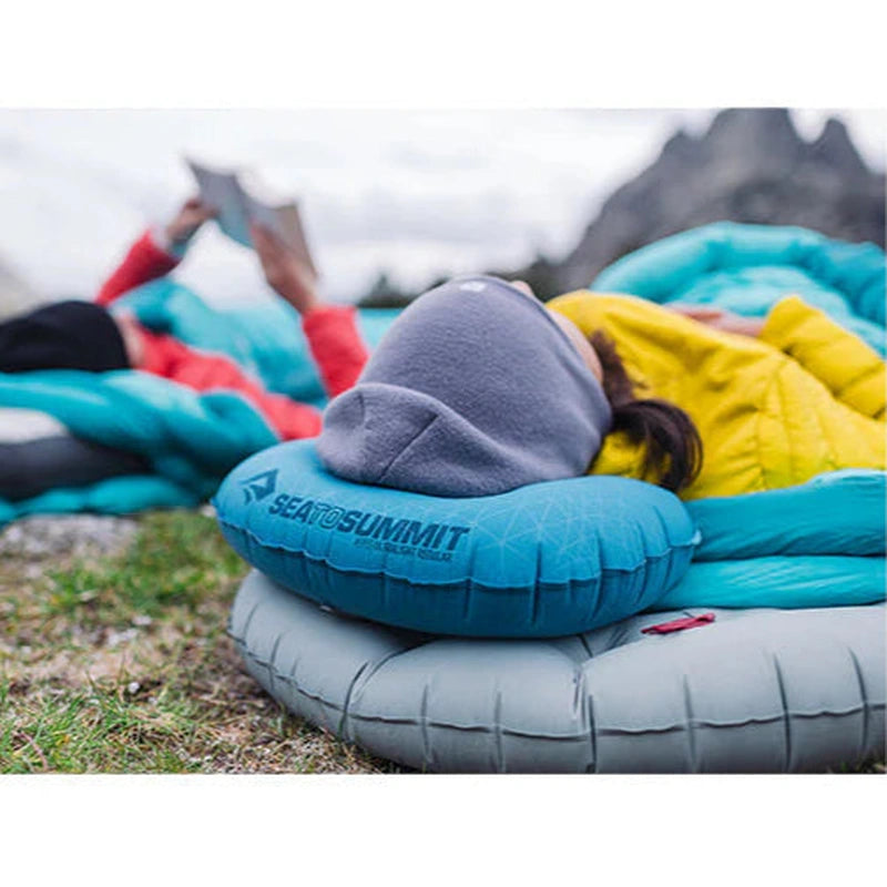 Person sover på sidan med blå Sea to Summit Aeros Ultralight kudde i utomhusmiljö