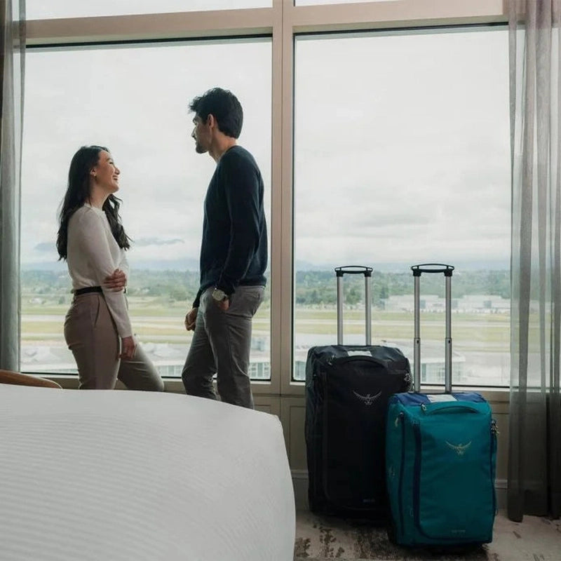 Två Osprey Daylite Wheeled Duffelbags svart och turkos i hotellrum